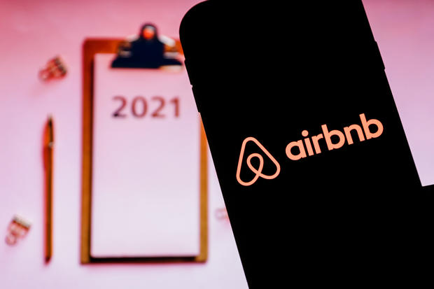 In this photo illustration an Airbnb logo seen displayed on 