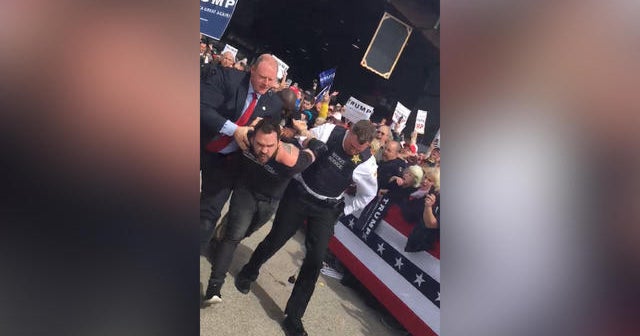 Protester rushes Trump on rally stage, gets kicked out of event - CBS News