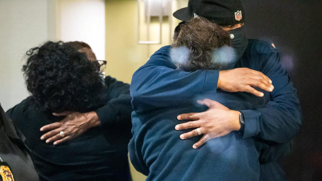 People embrace after learning their loved one was safe after a mass shooting at the FedEx facility in Indianapolis, Indiana, April 16, 2021. 
