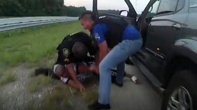 Stephanie Bottom is seen on the ground during a May 2019 traffic stop in North Carolina in an image capture from bodycam video. 