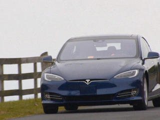 Tesla rolls out first Model 3 - CBS News