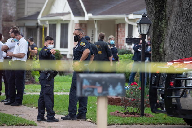 Police officials stand outside Houston residence 