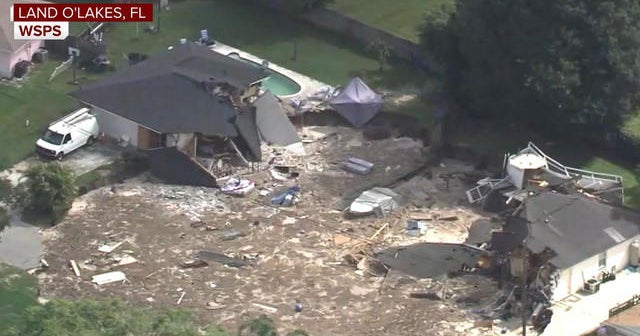Sinkhole swallows homes in Florida neighborhood CBS News