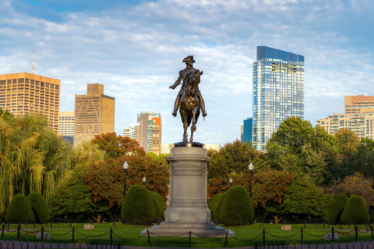 George Washington Equestrian Statue at Public Garden with office business building downtown district in Boston, Massachusetts, USA. USA tourism, modern city life, or business finance and economy concept 