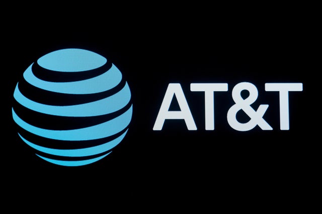The company logo for AT&T is displayed on a screen on the floor at the NYSE in New York.