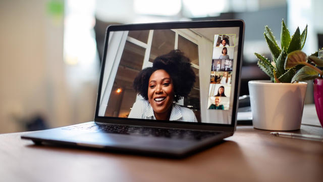 Businesswoman having a video call meeting with her team 