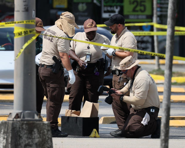 Miami-Dade police officers collect evidence after a mass shooting outside a banquet hall that had been rented out for a concert on May 30, 2021, in Hialeah, Florida. 