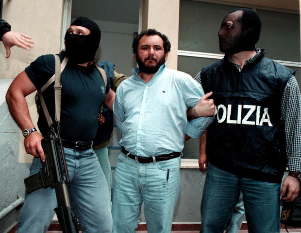 FILE PHOTO: Anti-Mafia police wearing masks to hide their identity, escort top Mafia fugitive Giovani Brusca May.. 