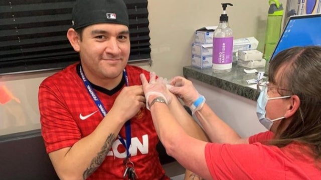 Eric-Ramirez-receives-his-COVID-19-vaccination-Thursday-at-a-UCHealth-mobile-COVID-19-vaccination-clinic-parked-at-Empower-Field-at-Mile-High-in-Denver..jpg 