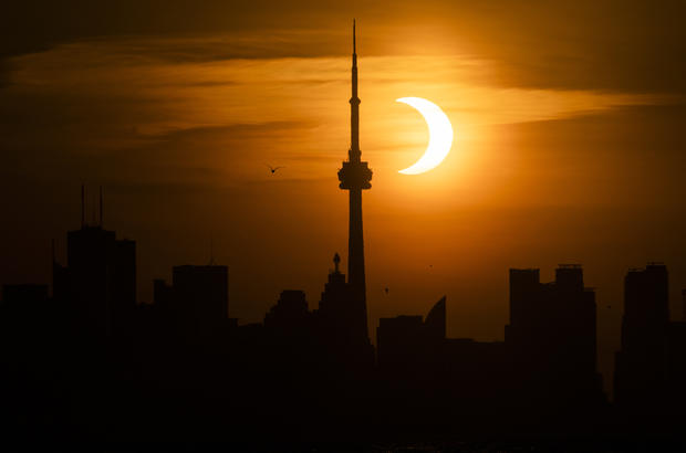 Rare Sunrise Eclipse Rises Beyond Toronto's CN Tower 
