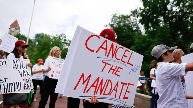 Protesters holding placards gather at Indiana University's 