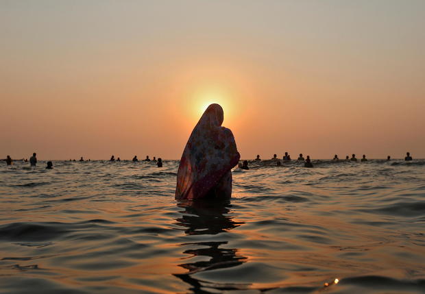 FILE PHOTO: Hindu devotees worship the Sun god in the waters of the Arabian Sea during Chhath Puja in Mumbai 