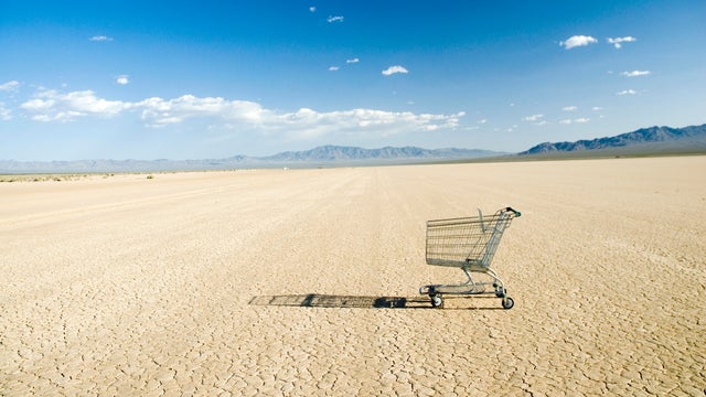 Empty shopping cart in desert 
