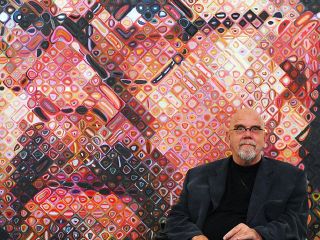 US artist Chuck Close sits in front of o
