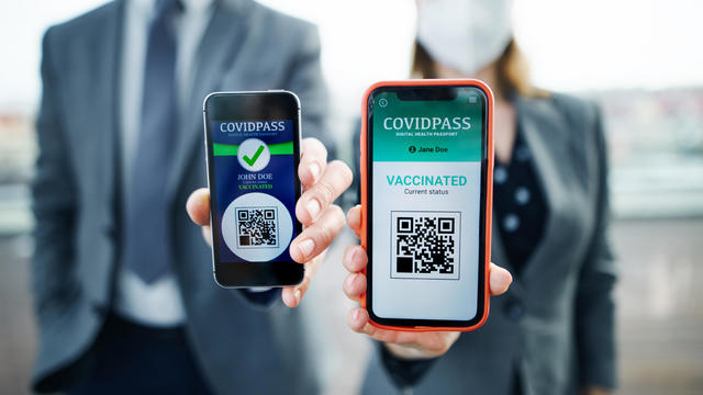 Man and woman showing vaccine passort at the airport, business and coronavirus concept. 