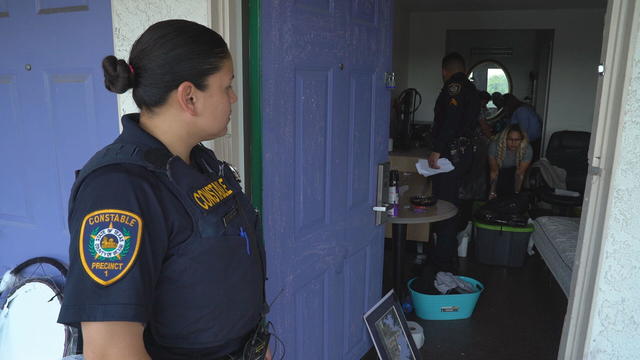 deputy-valencia-keeps-watch-as-crews-clear-the-apartment.jpg 