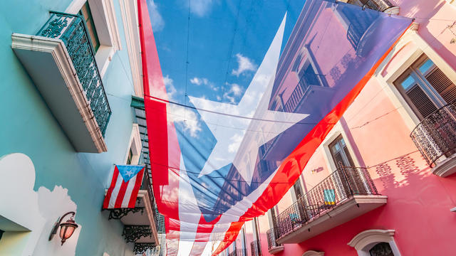 Large flag of Puerto Rico above the street in the city center of San Juan. 