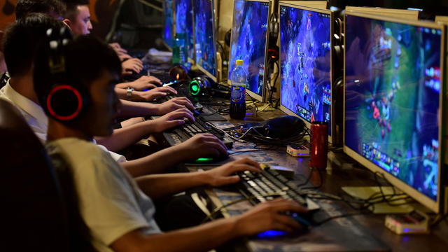 FILE PHOTO: People play online games at an internet cafe in Fuyang 