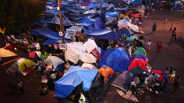 Migrants Huddle In Camps And Shelters In Tijuana Waiting To Cross Into U.S. 
