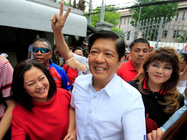 FILE PHOTO: Ferdinand "Bongbong" Marcos, son of late dictator Ferdinand Marcos, his wife, Louise (L) and his sister Imee (R) smile upon arrival at the Supreme Court in Padre Faura 