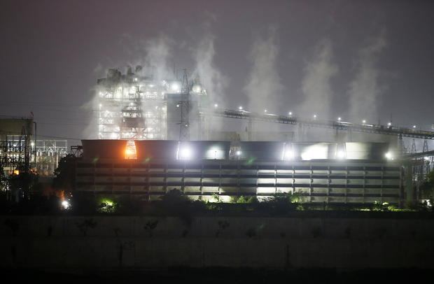 Smoke billows from the cooling towers of a coal-fired power plant in Ahmedabad 