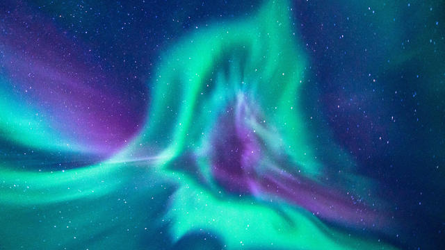 aurora borealis looks like phoenix display directly above the head in Iceland 