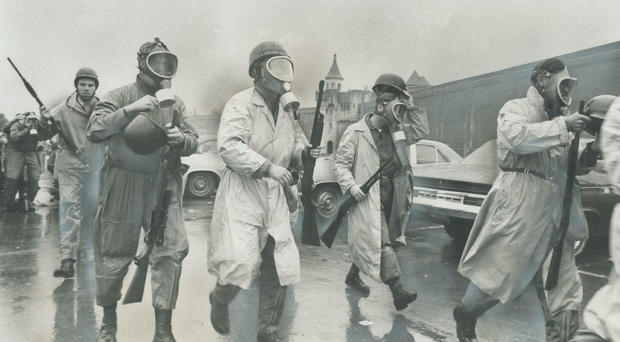 Saving in to crush riot; National Guardsmen wearing gas masks prepare to storm Cellblock D; the stro 