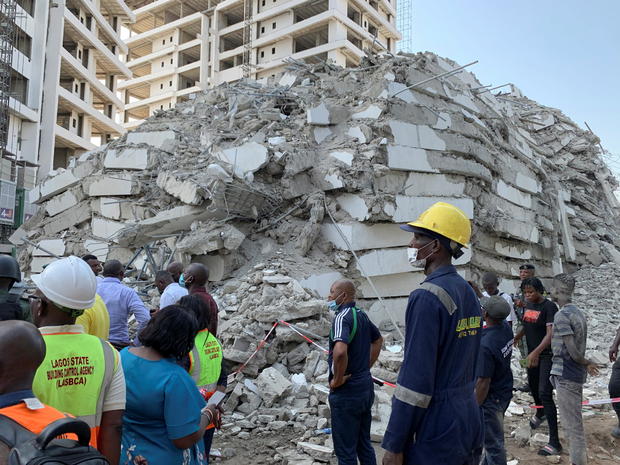 Emergency personnel stands by the debris of the collapsed building in Ikoyi 