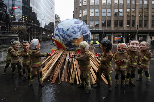 Oxfam campaigners demonstrate during COP26 in Glasgow 