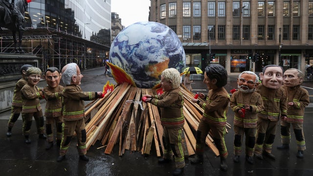 Oxfam campaigners demonstrate during COP26 in Glasgow 