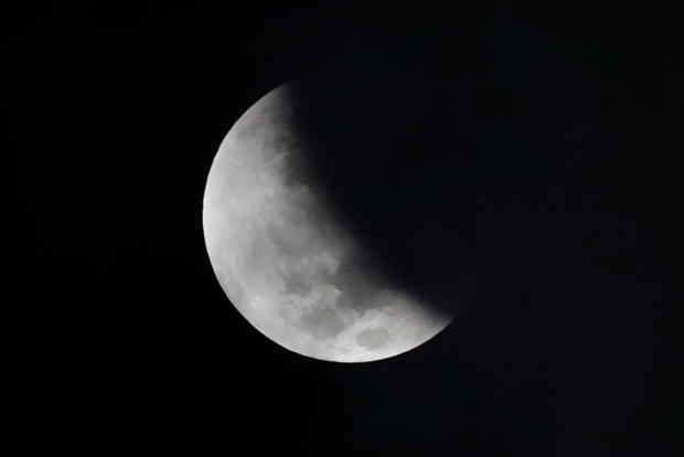 Shadow falls on the moon as it undergoes partial lunar eclipse as seen from Mexico City 