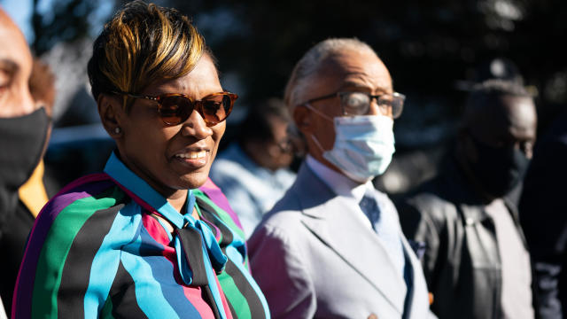 Wanda Cooper-Jones, mother of Ahmaud Arbery, arrives at the Glynn County Courthouse with the Rev. Al Sharpton as the jury deliberates in the trial of the killers of Ahmaud Arbery on November 24, 2021, in Brunswick, Georgia. 