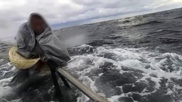 An image capture from video shows a man being rescued by Japan's coast guard after he drifted in choppy waters for nearly a day. 