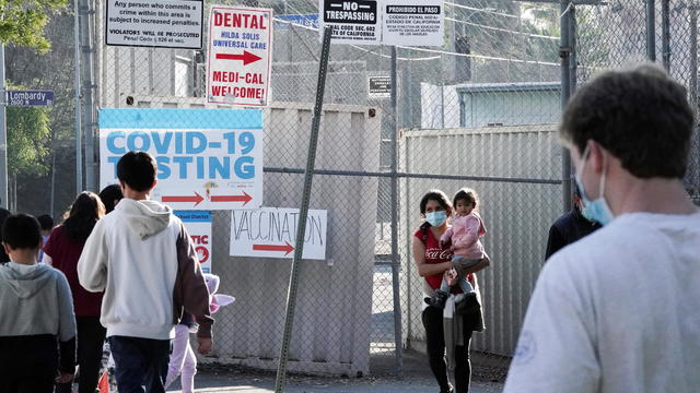 Los Angeles Unified School District staff distributes free COVID test kits. 