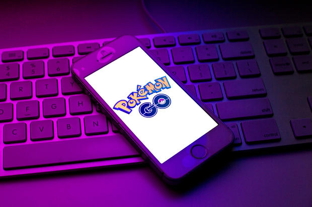 In this photo illustration a Pokemon GO logo seen displayed 