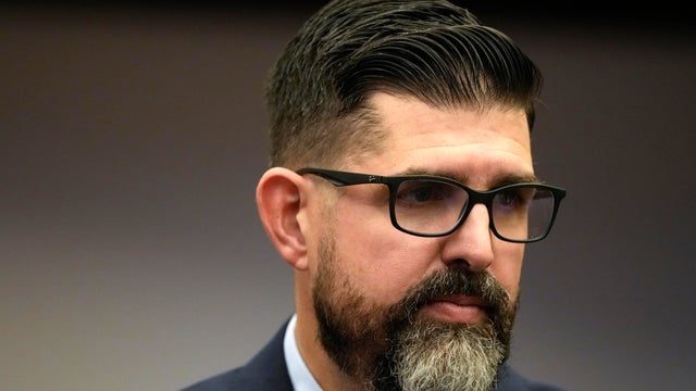 Florida state Senator Manny Diaz Jr. walks in the Senate chamber following the opening of a special legislative session targeting COVID-19 vaccine mandates, November 15, 2021, in Tallahassee, Florida. 