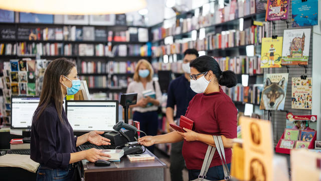Interior of a local bookstore with people buying books 