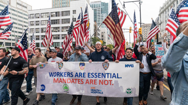 Municipal workers of the city march across Brooklyn bridge 