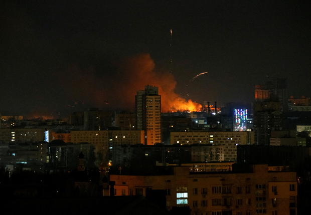 Smoke and flames rise over during the shelling in Kyiv 