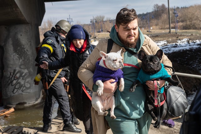 A man seen with his dogs during the evacuation.Thousands of 