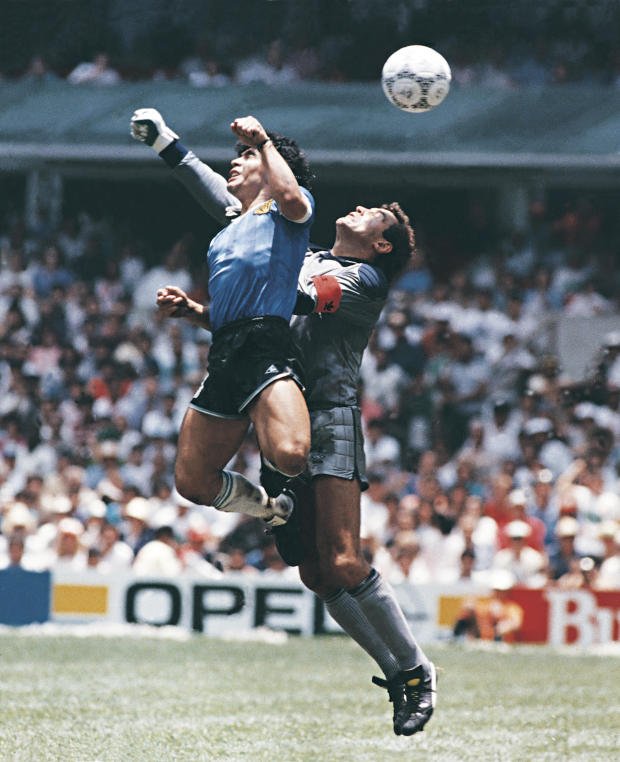 Diego Maradona of Argentina uses his hand to score the first goal of his team during a 1986 FIFA World Cup quarter-final match between Argentina and England at Azteca Stadium on June 22, 1986, in Mexico City, Mexico. Maradona later claimed that the goal was scored by "the hand of God." 
