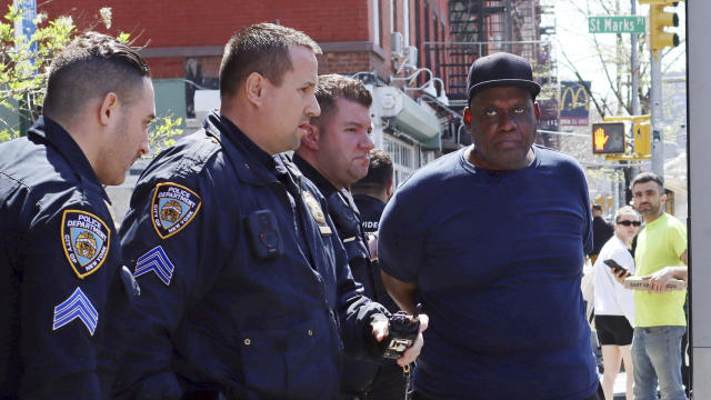 New York City Police Department officers arrest subway shooting suspect Frank R. James, 62, in the East Village section of New York, April 13, 2022. 