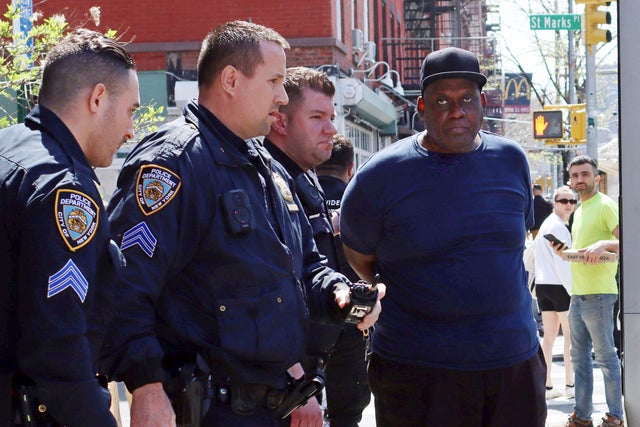 New York City Police Department officers arrest subway shooting suspect Frank R. James, 62, in the East Village section of New York, April 13, 2022. 
