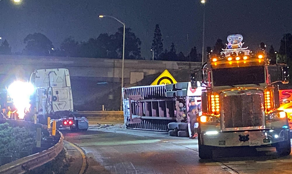 Big rig on its side blocks freeway transition road in Cerritos for ...
