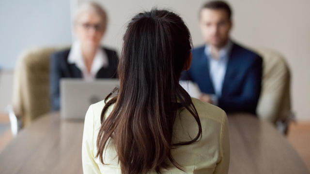 Businesswoman and businessman HR manager interviewing woman 