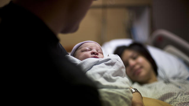 Newborn baby with parents in hospital 