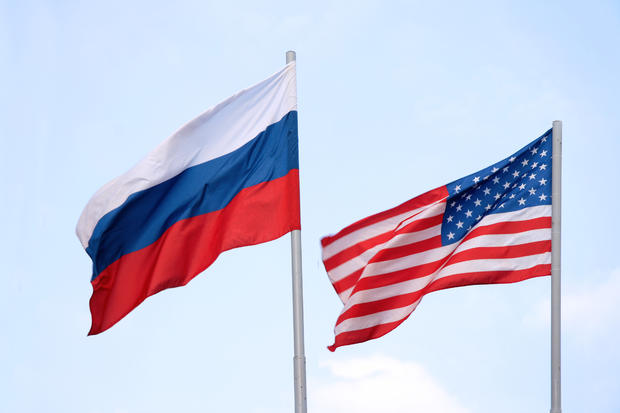 The Russian and American flags flying side by side 