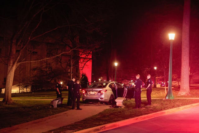 Members of law enforcement secure the scene of a vehicle 