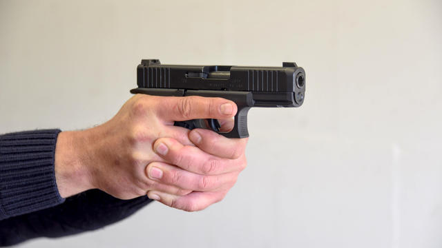 Policeman points a pistol at a shooting range 