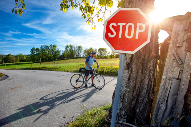 stop sign bicycle cycle Senior Man Cycler Stopping on Country Road Crossroad 